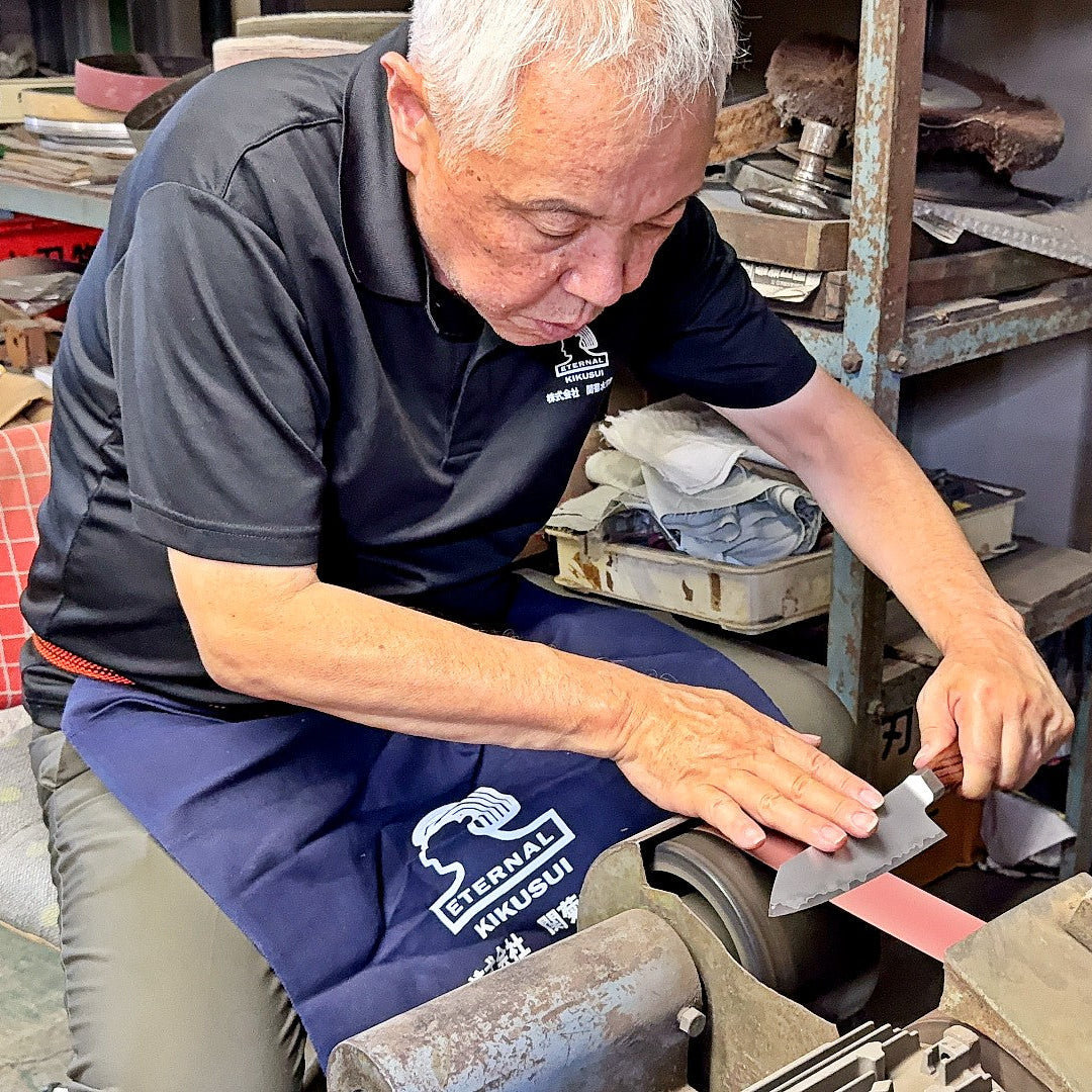 Seki Kikusui craftsman sharpening VG-10 stainless steel KIRINAMI Kiritsuke Bunka by hand in his workshop