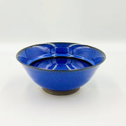 Side view showing inside of Blue Glazed Bowl crafted by Imari Togei craftsmen on light cream background