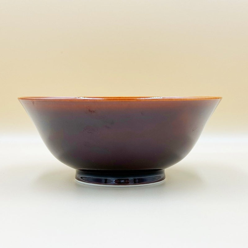 Side view of Amber Glazed Bowl crafted by Imari Togei craftsmen on light cream background