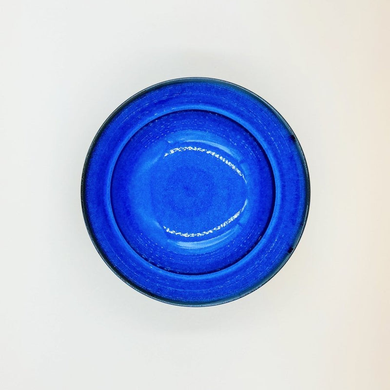 Aerial view of Blue Glazed Bowl crafted by Imari Togei craftsmen on light cream background