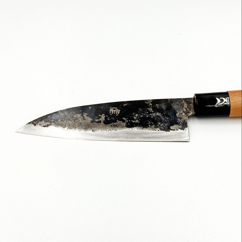 Closeup on blade of Kawasaki Blacksmith Kurouchi Santoku Knife 160mm on white background