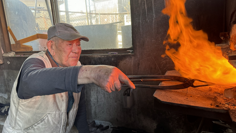 Minomo Blacksmith 8th generation craftsman, Grandad Yutaka san, picking a blade from the fire