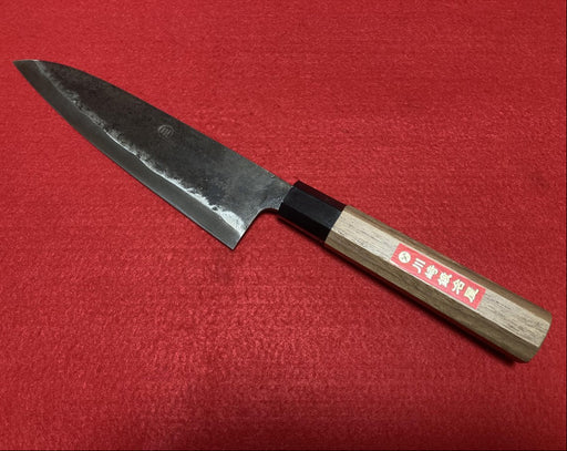 Kurouchi Gyuto Kitchen Knife 180mm crafted by Kawasaki Blacksmith diagonal on red background (front)