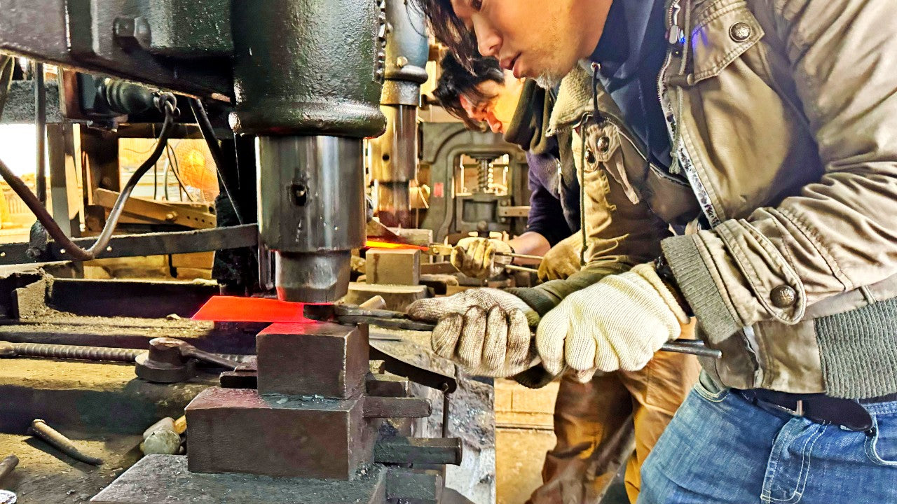 Kurotori Blacksmith craftsman hammers steel into shape with a machine