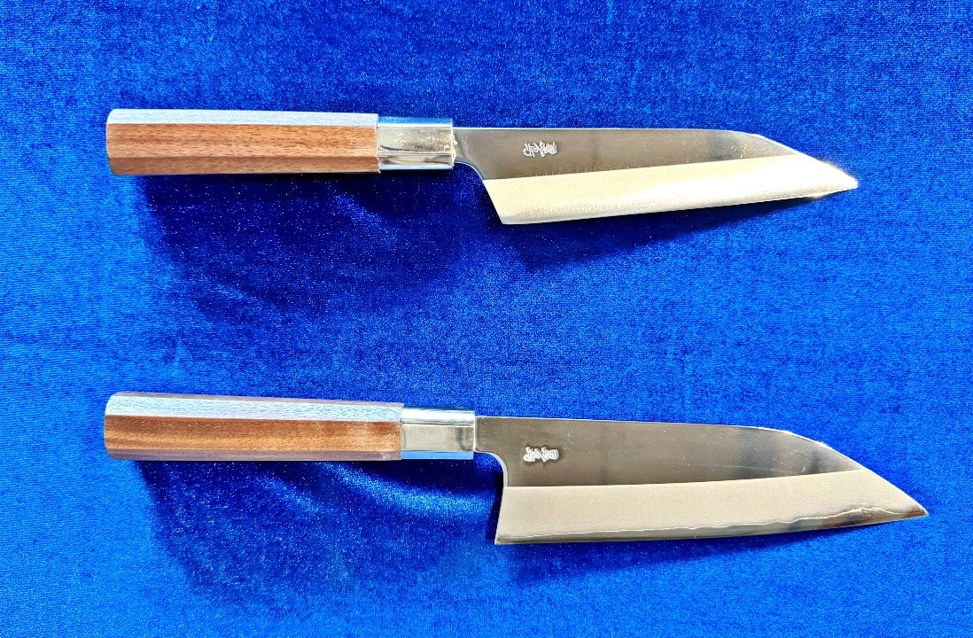 Petit knife and Full size knife are arranged on a blue fabric.