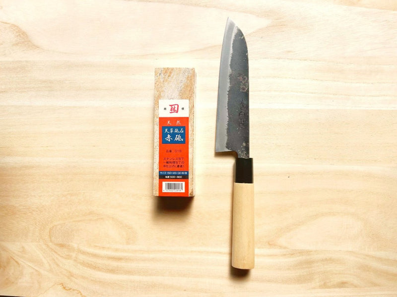 Minomo Blacksmith Santoku Knife next to Amakusa Red Sharpening Stone