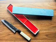 Minomo Blacksmith Santoku Knife Pack with blade engraving next to its open box