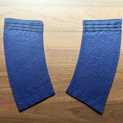 Blue Yatai Keiji wristbands on a light wooden background