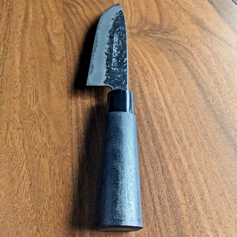 Closeup of the Minomo Blacksmith Knife No.8 185mm black handle