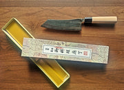 Curved Back Bunka Kitchen Knife 165mm by Nakamura Hamono nexts to its open box showcasing the label with Japanese characters