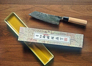 Bunka Kitchen Knife 180mm by Nakamura Hamono next to its open box showing the label with Japanese characters