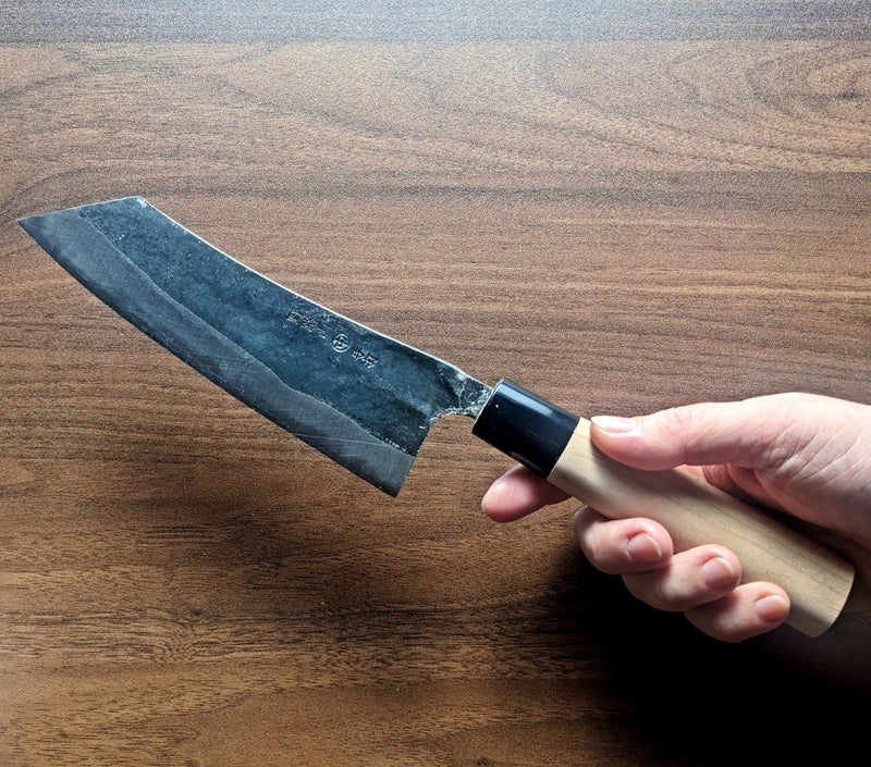 Hand holding a Curved Back Bunka Kitchen Knife 165mm by Nakamura Hamono