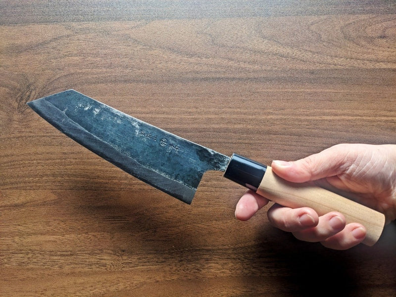Hand holding Bunka Kitchen Knife 180mm by Nakamura Hamono