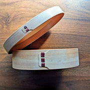 Side profile of open Oval Bento Box crafted by Hakata Bentwood Tamaki on wooden background