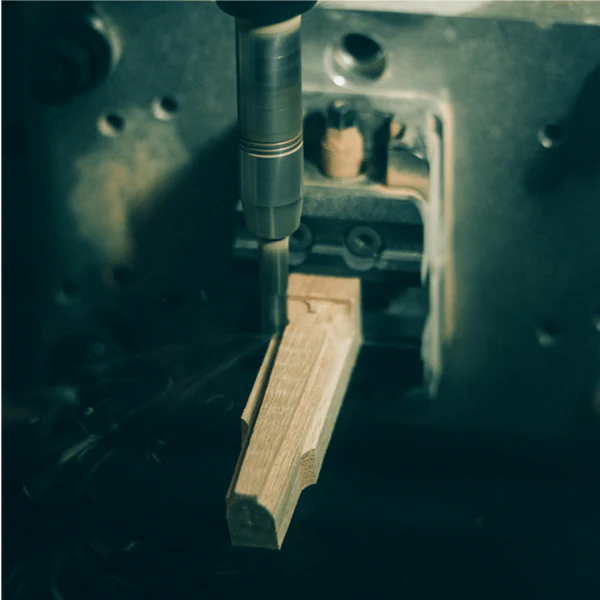 Closeup of a machine cutting the wood for the KISEKI santoku handle