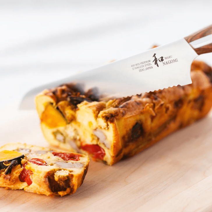 Hand cutting fruit cake with NAGOMI Bread Knife 205mm by Mitsuboshi Cutlery