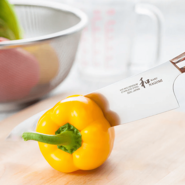 Hand slicing yellow bell pepper with NAGOMI Santoku Knife 180mm crafted by Mitsuboshi Cutlery
