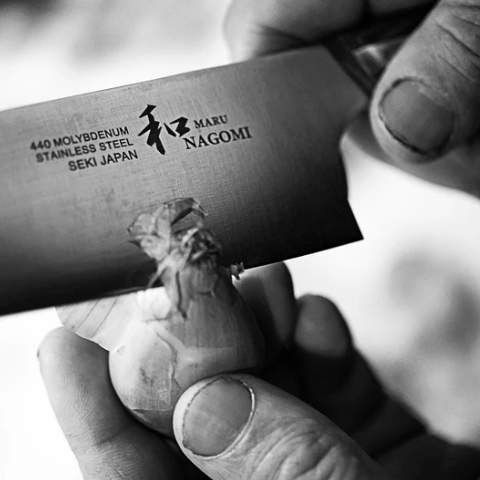 Hands cutting garlic with NAGOMI Petty Knife 155mm crafted by Mitsuboshi Cutlery