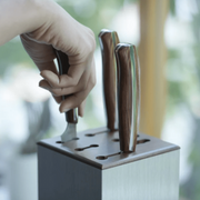 Hand taking a knife out of NAGOMI Knife Stand by Mitsuboshi Cutlery