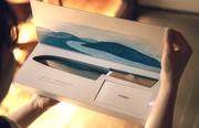 Closeup of a woman opening the gift box with the KISEKI Santoku Knife inside
