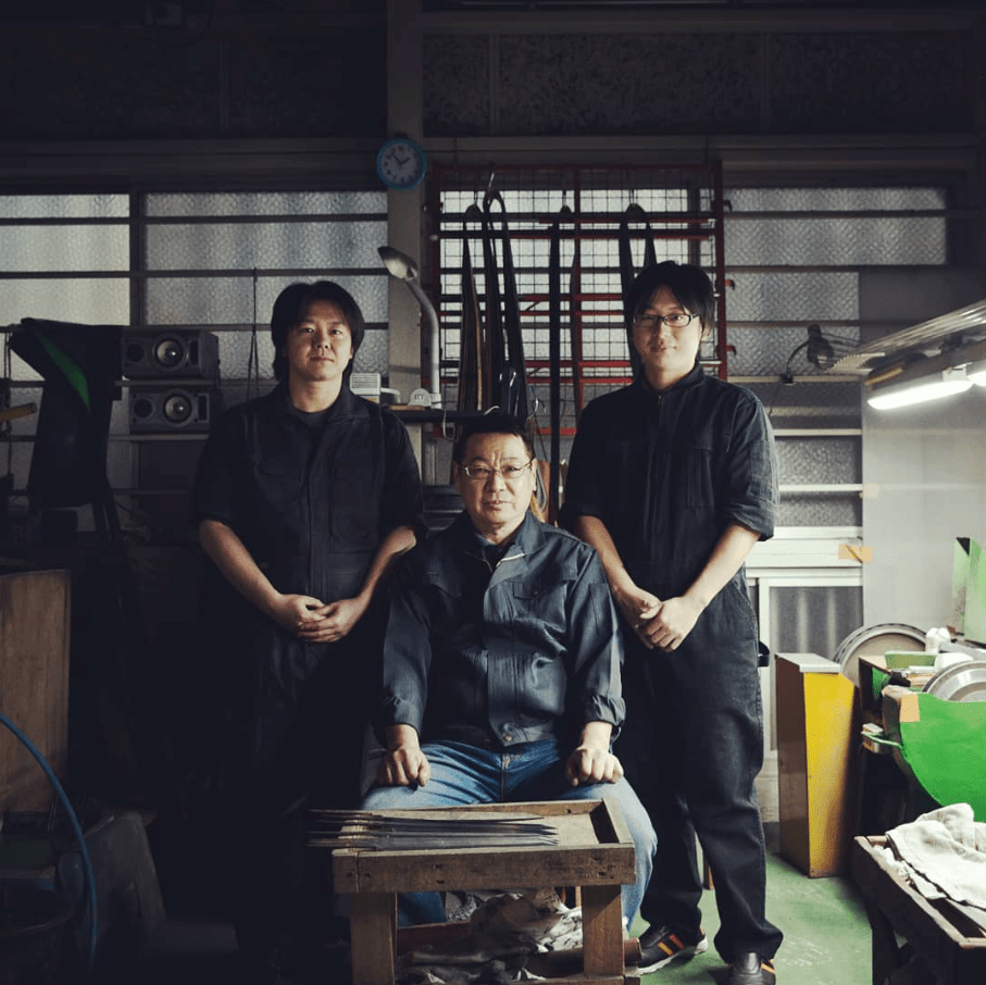 Three blacksmiths from Aoki Hamono inside the polishing station of the workshop in front of unpolished blades of Sakai TAKAYUKI knives