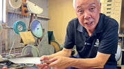 Craftsman showing reverse side of blade of VG-10 stainless steel KIRINAMI Kiritsuke Bunka by Seki Kikusui Cutlery in his workshop