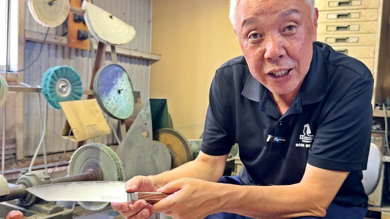Craftsman showing reverse side of blade of VG-10 stainless steel KIRINAMI Kiritsuke Bunka by Seki Kikusui Cutlery in his workshop
