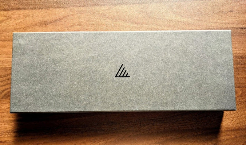 Close-up of the grey box of Special All - Purpose Gyutoku Kitchen Knife 185mm over a wooden table
