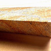 Closeup on speckled color of red sharpening stone