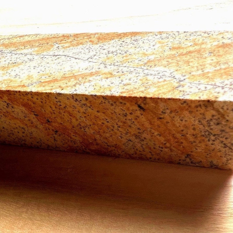 Closeup on speckled color of red sharpening stone