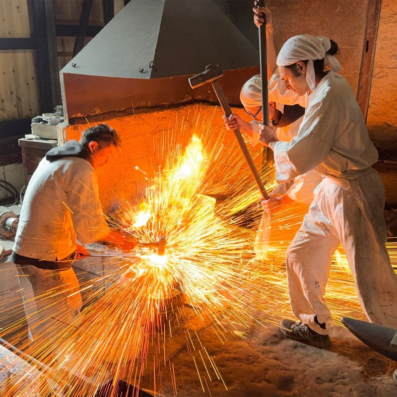 Asano Blacksmith forging in their workshop with sparks flying