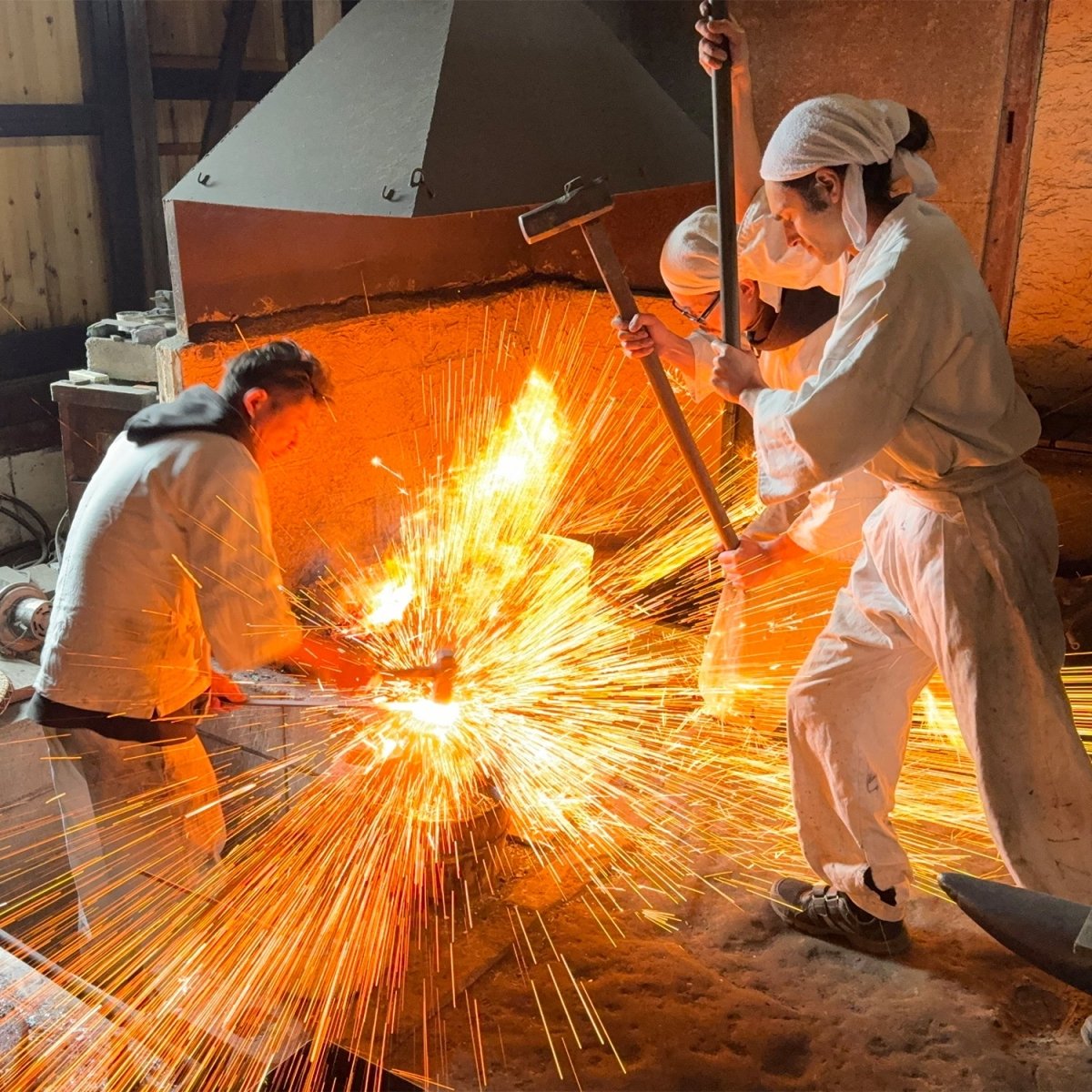 Asano Blacksmith forging in their workshop with sparks flying