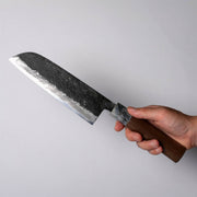 Hand holding a Miwa Hamono Kurouchi Aogami No.1 Santoku Knife 165mm