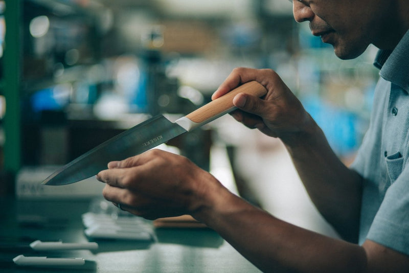 Craftsman inspecting the KISEKI Santoku Knife lade in the 
