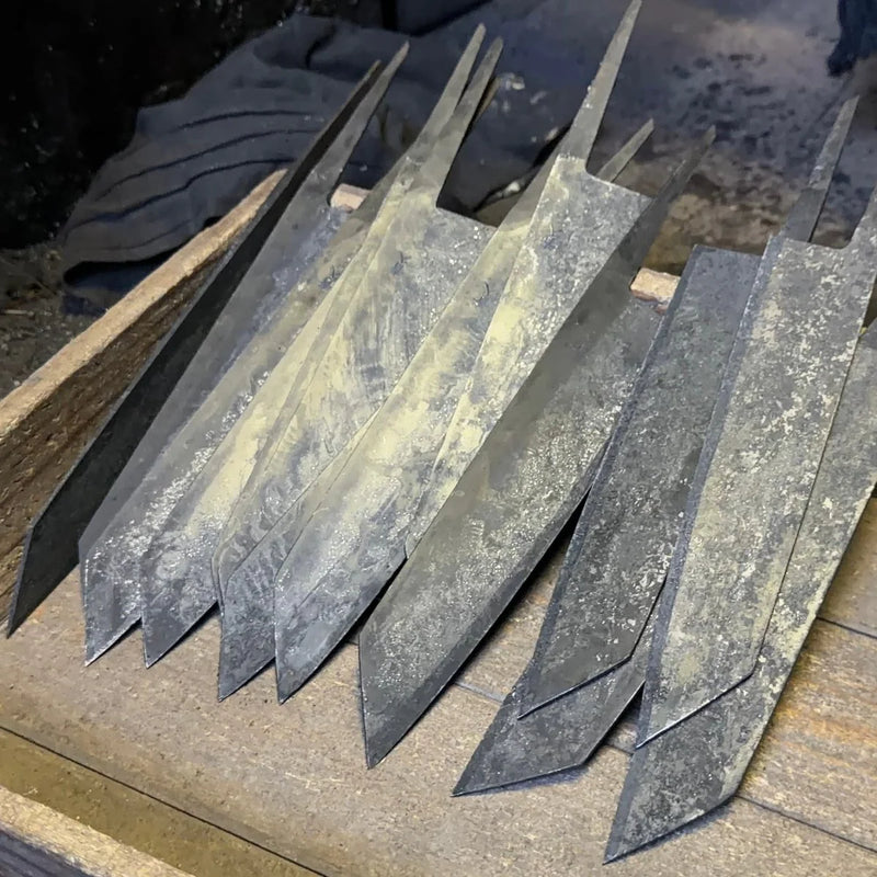 A group of unpolished Kajihara Hamono kiritsuke blades in a wooden box