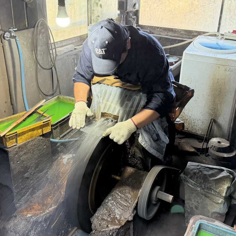 Kajihara Hamono master artisan polishing a blade