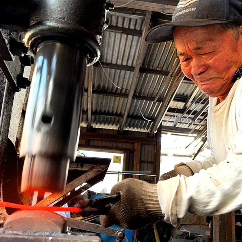 Toshio Nakamura hammering a handcrafted Japanese knife in his workshop