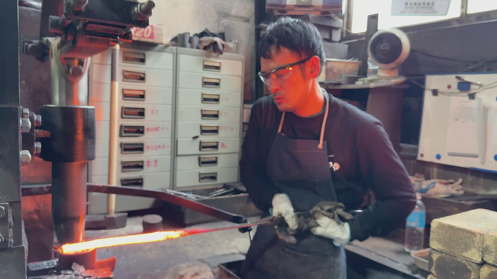 Satoshi Nakagawa, from Nakagawa Knives, hammering the heated metal in his workshop