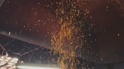 A Shirou Kunimitsu craftsman working the metal while sparks fly