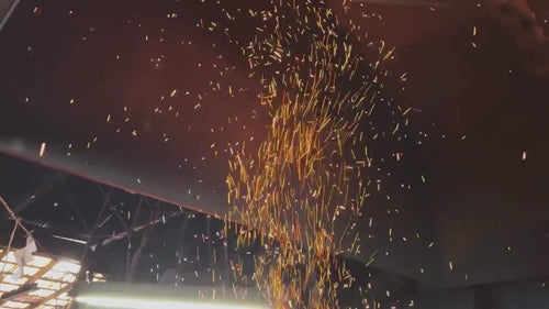 A Shirou Kunimitsu craftsman working the metal while sparks fly