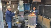 Ueta Norihito (Sukesada) and his fellow  blacksmith inside Bizen Osafune workshop working with hot tanks of metal