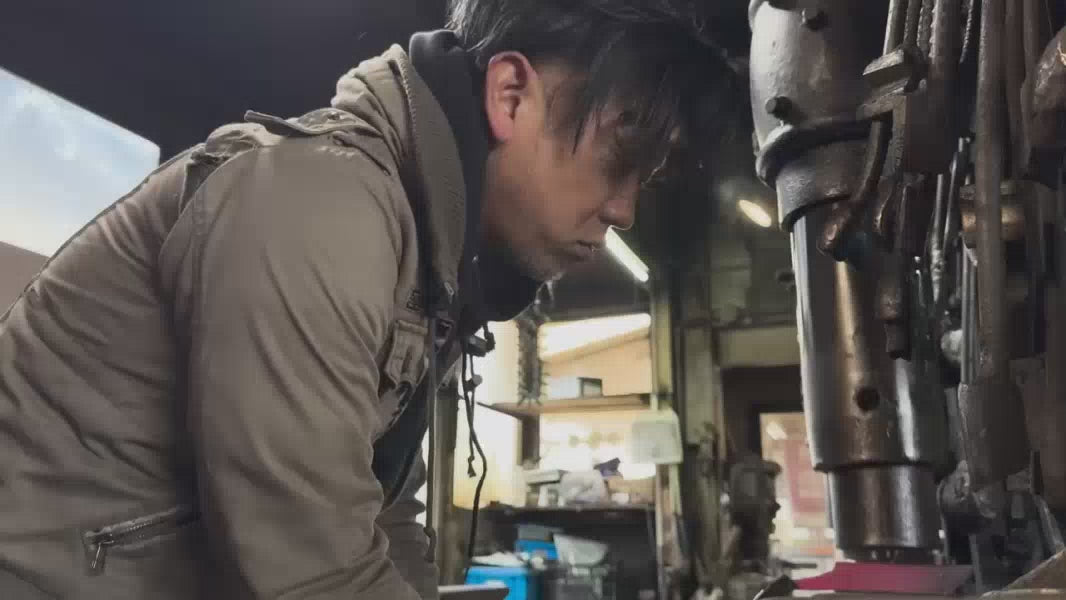 Blacksmiths in Kochi Prefecture work on handcrafting knives in their smithy in Kochi Prefecture, Japan.