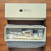 Kintsugi Repair Kit by Kintsugi Kurashi in box next to lid on wooden background