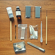 Parts included in Kintsugi Repair Kit by Kintsugi Kurashi displayed on wooden background without box