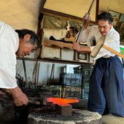Shirou Kunimitsu craftsmen hammering a hand-forged knife in their workshop